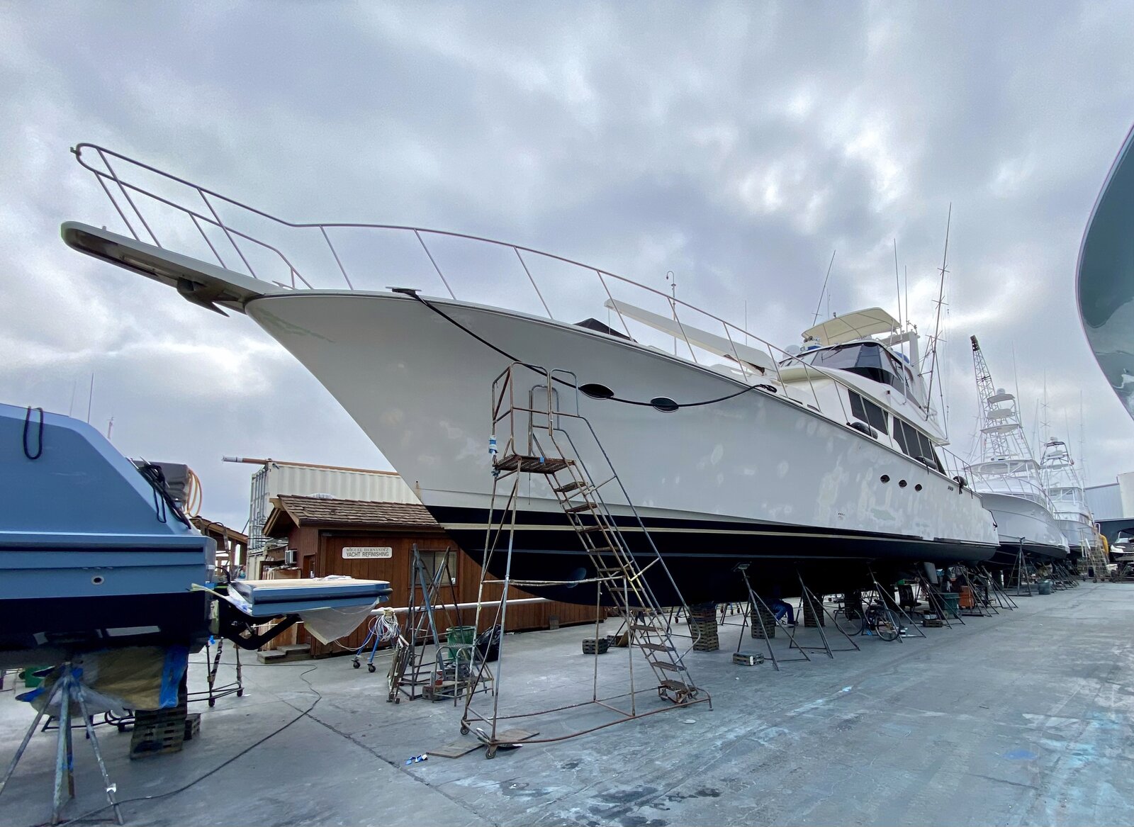 Dark hull commercial boat wrap front bow view, marine-grade 3M vinyl